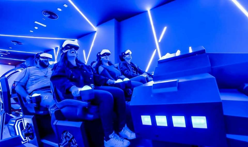 a group of teens playing vr game